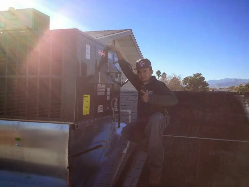 HVAC technician performing HVAC Inspection on a rooftop unit in Hidden Valley